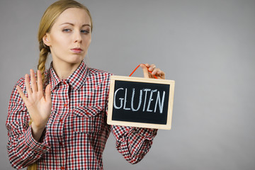 Woman holding board with gluten sign