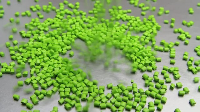 Plastic pellets spilling on background .Polymeric dye ,a colorant for plastics. Plastic resin
