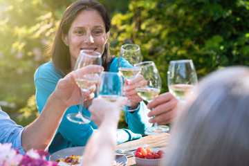woman in a group of friends gathered around a table