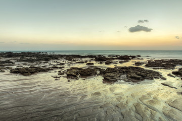Beach in evening, after sunset during low tide showing sand formations and rocks not covered by the sea. Klong Nin, Koh Lanta, Thailand.