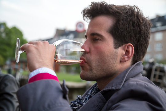 Young man drinking a glass of wine