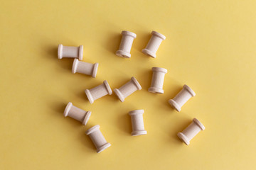 a group of spools in a yellow background