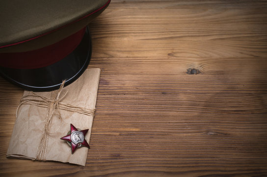 9 nine may Victory day concept background. The Great Patriotic War. Order (medal) of the red banner star, military cap and notes from the front...