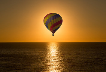 Aerostatic balloon in the sea on a sunrise