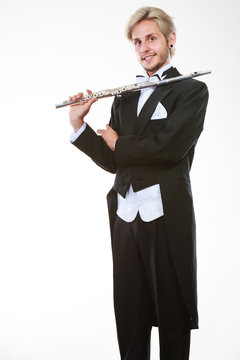 Male flutist wearing tailcoat holds flute