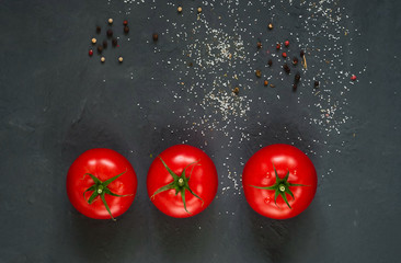 dark background with spices and fresh red tomatoes, close-up, top view, concept of cooking ketchup, copy space, minimalism