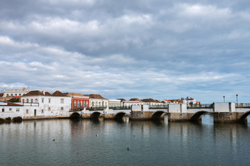 Fototapeta na wymiar Historic buildings and famous Roman bridge in the center of Tavira, Portugal