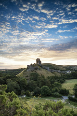 Obraz premium Old medieval castle ruins in vibrant Summer sunrise landscape image