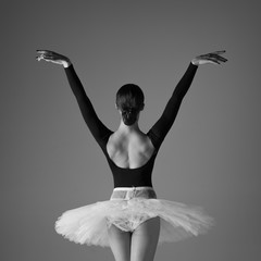 Young beautiful ballerina is posing in studio