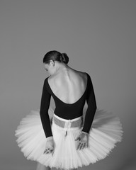 Fototapeta premium Young beautiful ballerina is posing in studio