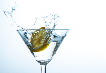 Glass of water with lemon with splash with copy space on white