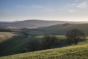 Stunning vibrant sunrise landscape image over English countryside landscape with lovely light hitting the hills