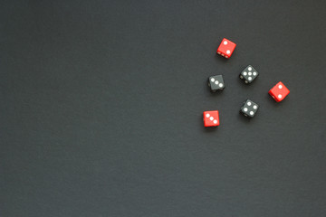 six colored dice on a dark fabric