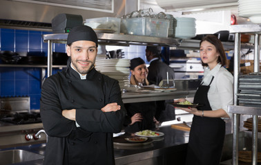 Fototapeta na wymiar Confident chef in restaurant kitchen