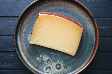 Delicious organic Italian cheese on plate top view 