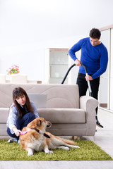 Husband cleaning house from dog fur