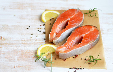 Salmon Trout Fish Cooking Raw Fillet Pepper Salt Olive Oil Rosemary Lemon Green Tomato Salad Wooden Table Lifestyle Healthy Concept