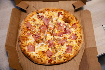 Hot Italian pizza with cheese in delivery box