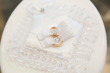 Gold wedding rings on the stand for rings