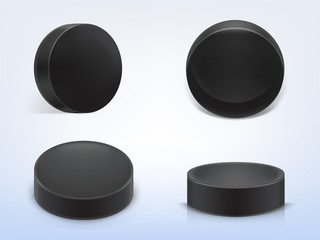 Vector set of 3d realistic black rubber pucks for play ice hockey isolated on light background. Sport equipment, hard round disk, inventory for winter team game on skating rink - obrazy, fototapety, plakaty
