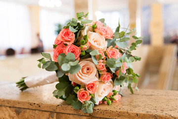 Beautiful bridal bouquet of different flowers with eucalyptus leaves