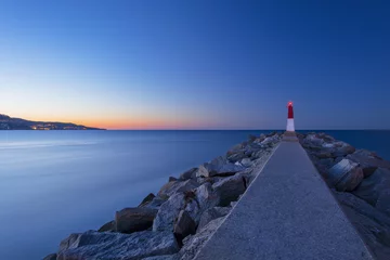 Papier Peint photo Phare Picturesque sunset sea landscape with a lighthouse (Empuriabrava, Spain)