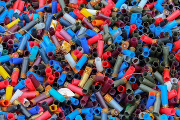 Background of many colorful shot empty shotgun shells