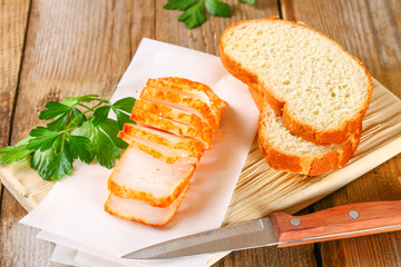 Pork lard with greens on a wooden table.