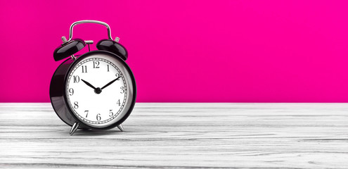 alarm clock on wooden board