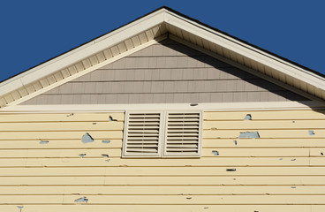 Holes in exterior siding in home from damage by hail storm  - obrazy, fototapety, plakaty
