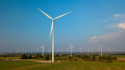 Fototapeta premium Wind turbine farm and agricultural fields. Energy Production with clean and Renewable Energy