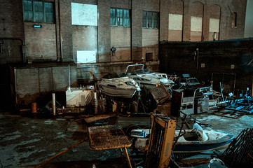Junkyard with boats and ships at night
