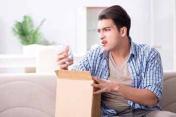 Obraz na płótnie Canvas Man receiving wrong parcel with glasses