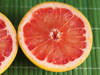 half red grapefruit on a green background