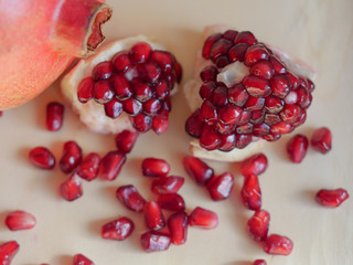 pomegranate with seeds fruit on wooden table