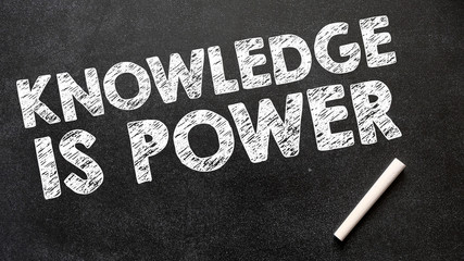 Knowledge is power inscription on dark chalkboard
