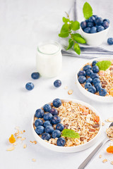 Homemade granola or oatmeal muesli with nuts, dried fruits and fresh berries. Healty diet breakfast, vegeterian food concept