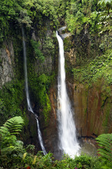 Fototapeta na wymiar Catarata Del Toro waterfall cascades down into an old volcano crater.