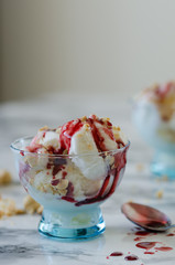 Vanilla ice cream in blue bowl,on white background,top view