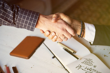 Business partnership meeting concept. Image of businessmans handshake. Successful businessmen handshaking after good deal. Horizontal, blurred background.
