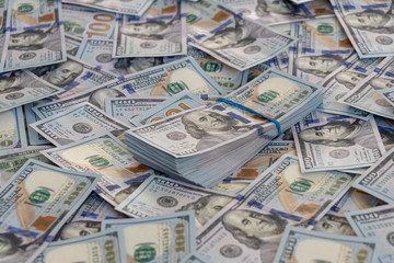 A pile of US banknotes with president portraits. Cash of dollar bills, dollar background image.
