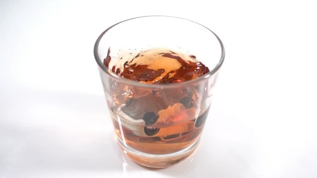 alcohol abuse, drunk driving - the car falls into a glass with alcohol, the concept of an accident while driving in a drunken state, Slow motion