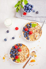 Homemade granola or oatmeal muesli with nuts, dried fruits and fresh berries. Healty diet breakfast, vegeterian food concept