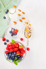 Homemade granola or oatmeal muesli with nuts, dried fruits and fresh berries. Healty diet breakfast, vegeterian food concept