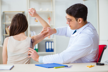 Doctor checking patients joint flexibility with gonimeter