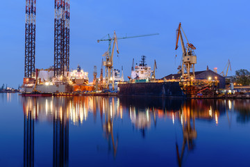 Oil rig docked in shipyard of Gdansk at night. Poland