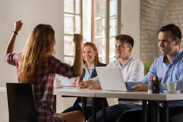 Young woman celebrating on a job interview in the office