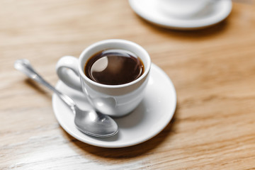 Cup of hot aroma Espresso coffee on the table in cafe