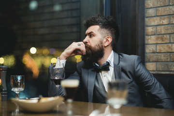 I know everything about wine. Confident male sommelier sitting at bar