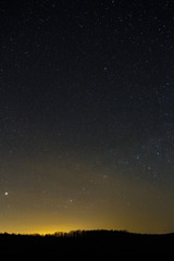 Stars of the Milky Way in the night sky. A view of the starry space background sunset illuminated the horizon.